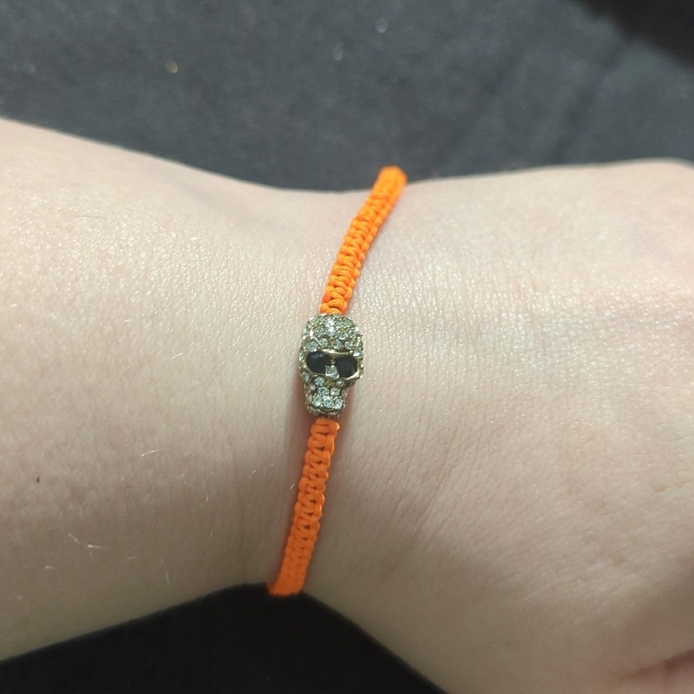 Gold Tone Orange Thread Clear and Black Rhinestone Skull Slide Style Bracelet